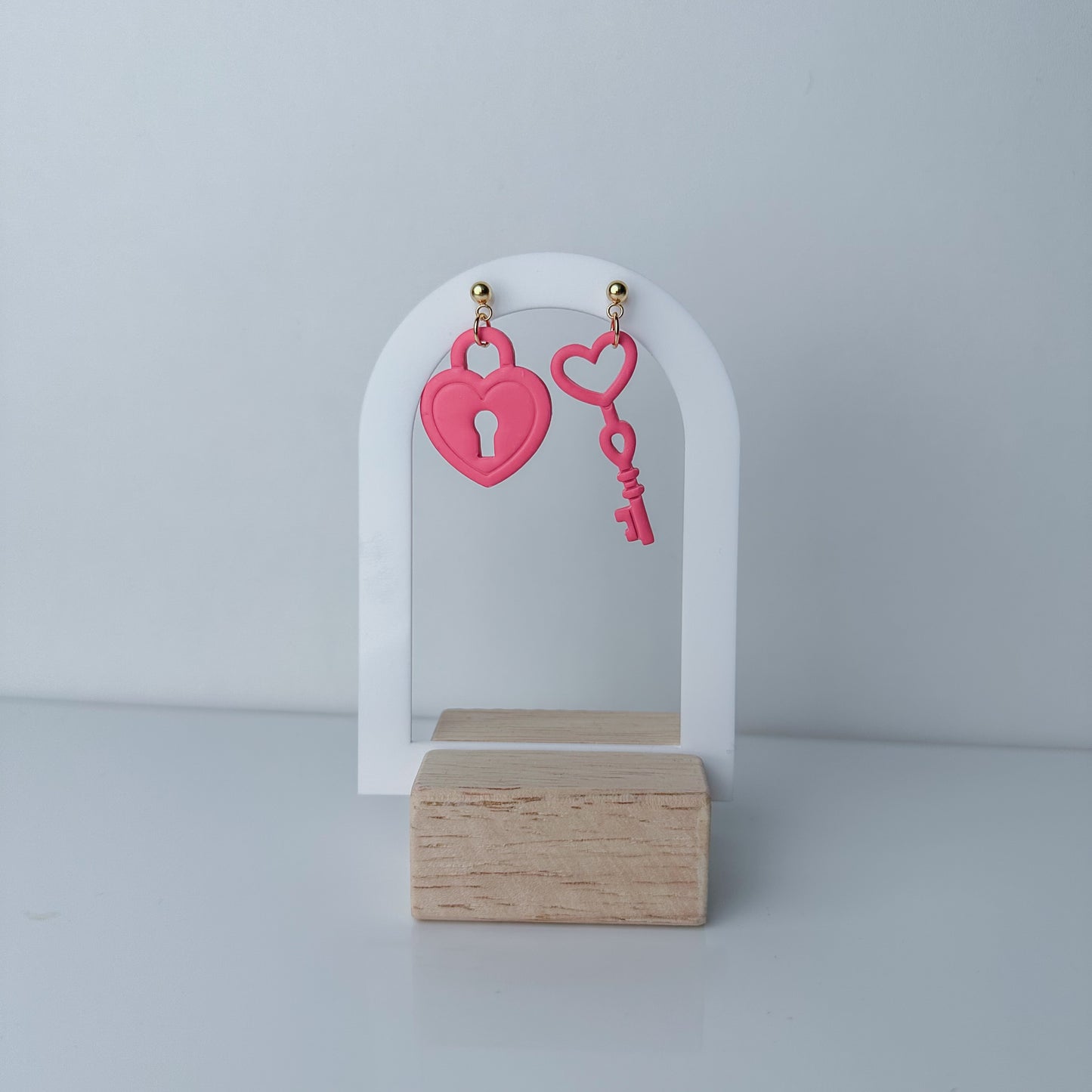 Handcrafted pink heart lock and key earrings by Purely Clayful, featuring bold statement design in a playful style.